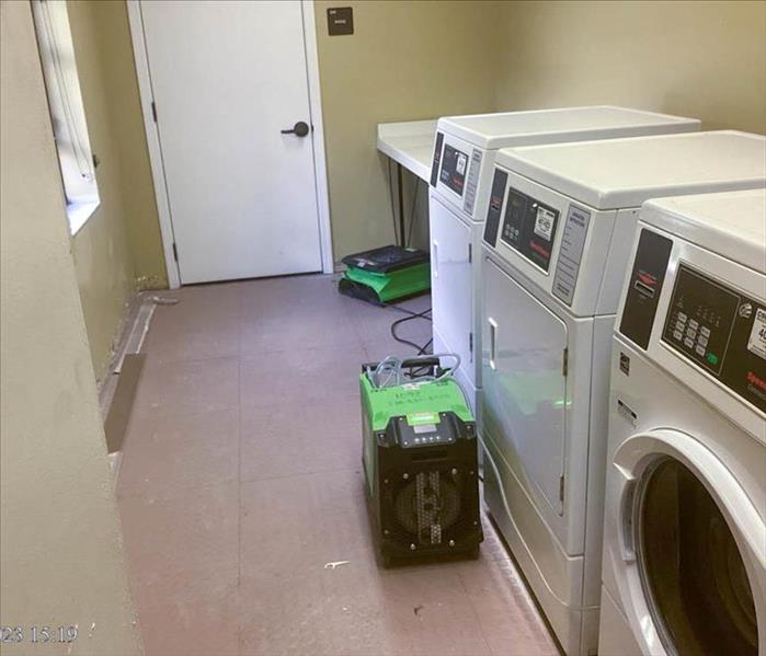 Drying equipment in a laundry room.